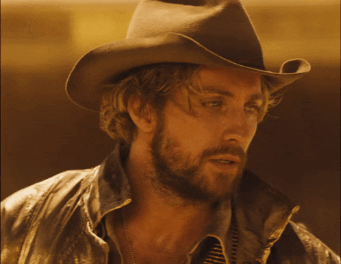 a man wearing a cowboy hat and a leather jacket