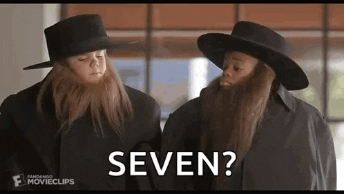 two children with long beards and hats are standing next to each other and talking to each other .
