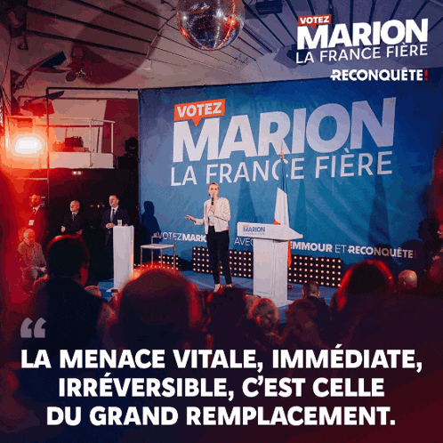 a woman stands at a podium in front of a sign that says vote marion la france fiere