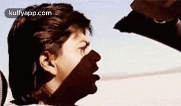 a close up of a man 's face with a shadow of a person on his face .