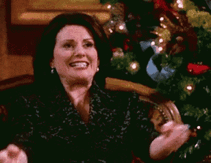 a woman is sitting on a couch in front of a christmas tree .