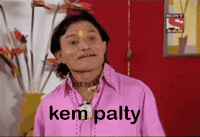 a man in a pink shirt has the word kem palty on his shirt