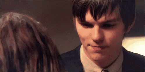 a close up of a man and woman looking at each other .