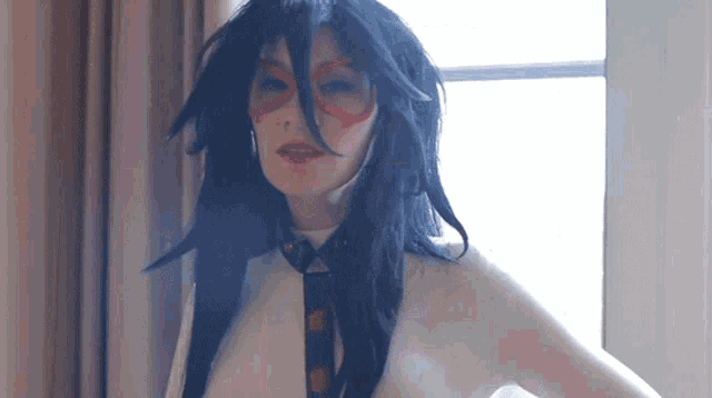 a woman with long black hair and red glasses