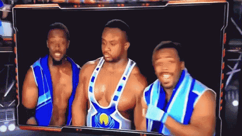 a group of wrestlers are standing next to each other