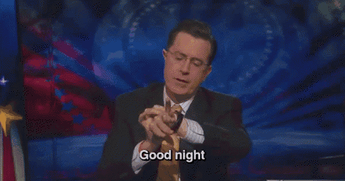 a man in a suit and tie is giving a thumbs up and saying good night .