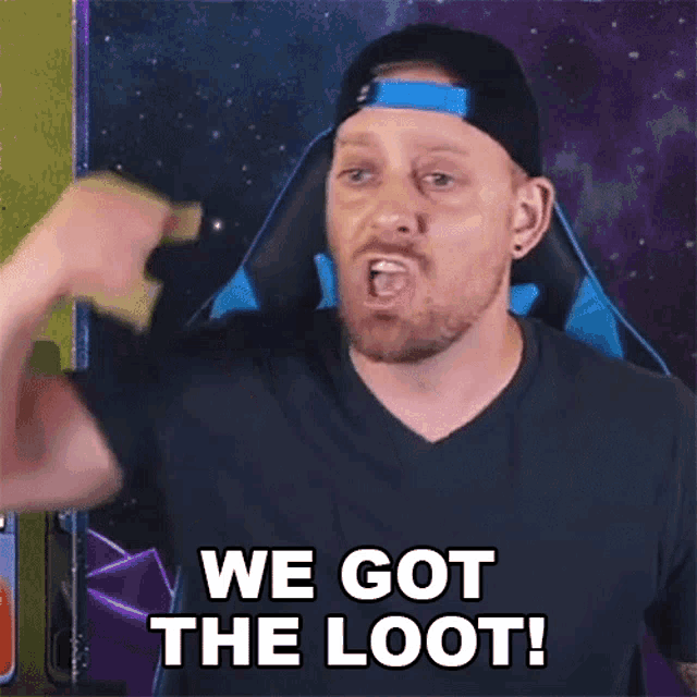 a man is flexing his muscles and saying we got the loot !