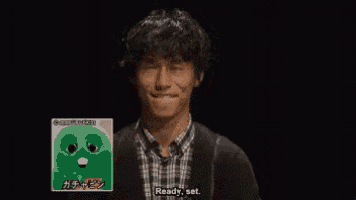 a man with a picture of a green stuffed animal behind him says his eyes