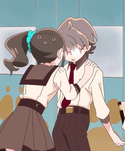 a boy and a girl are standing next to each other and the girl is covering the boy 's face