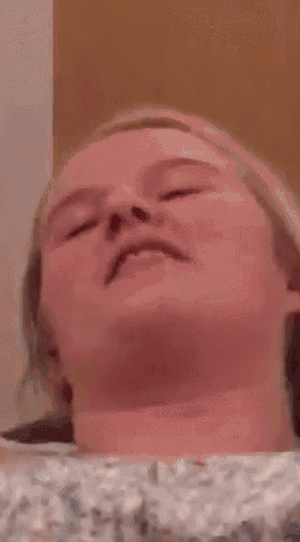 a close up of a person 's face with their mouth open .