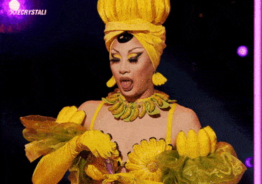 a drag queen is wearing a yellow outfit with bananas on it and the words xiecrystali above her