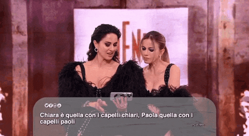 two women standing next to each other with a caption that says chiara e quella con i capelli chiari