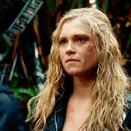 a close up of a woman 's face with long blonde hair