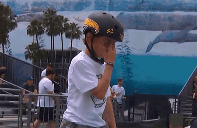 a person wearing a hot wheels helmet and a white shirt