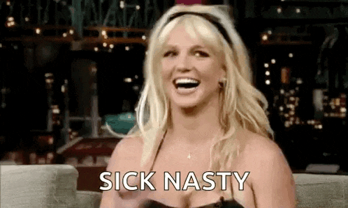 britney spears is laughing while sitting on a couch and saying sick nasty .