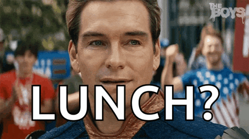 a man in a blue shirt says lunch in front of a crowd