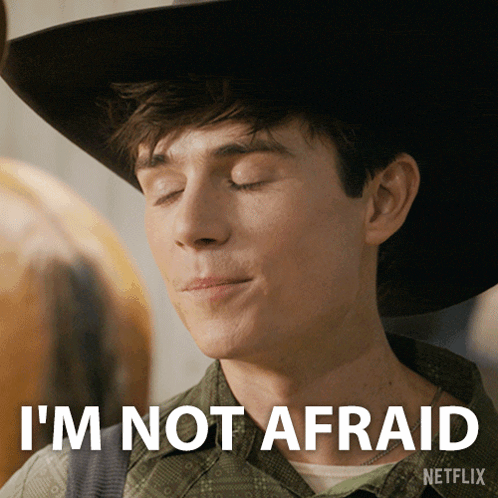 a young man wearing a cowboy hat says " i 'm not afraid "