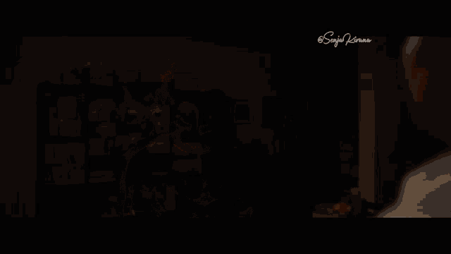 a man in an ant costume is talking to another man in a dark room