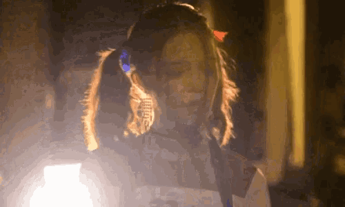 a woman with pigtails is wearing headphones and a ponytail .