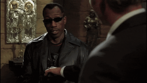 a man in a leather jacket says " you 're human barely i 'm a lawyer " in a movie scene
