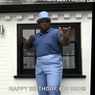 a man in a blue shirt and top hat is dancing in front of a house .
