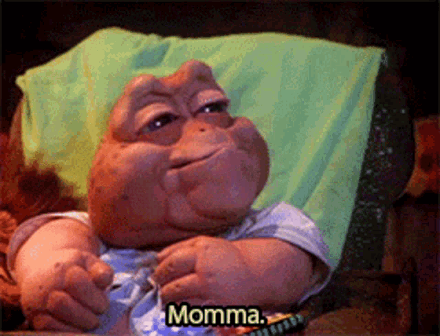 a stuffed animal is laying on a couch and says momma