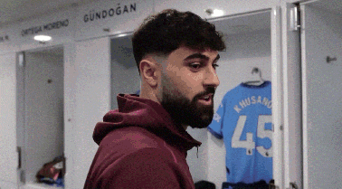 a man with a beard is standing in a locker room with a shirt that says 45 on it