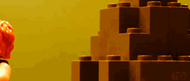 a lego figure stands next to a stack of lego blocks