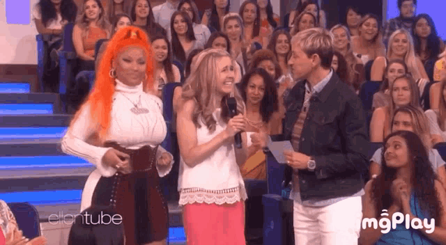 nicki minaj and ellen degeneres are talking to a woman in front of a crowd at ellentube