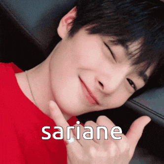 a young man in a red shirt is smiling and giving a thumbs up with the name sariane written below him