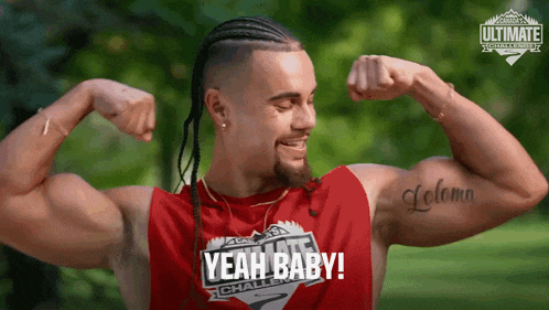 a man flexing his muscles with the words yeah baby written on his shirt