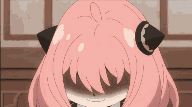 a cartoon girl with pink hair and black ears is smiling