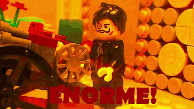 a lego figure standing next to a cannon with the word enorme written on the bottom