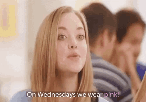 a woman is wearing pink on wednesdays while talking to a group of people .
