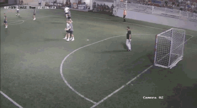 a group of soccer players are playing on a field with a camera that says camera 02 on it