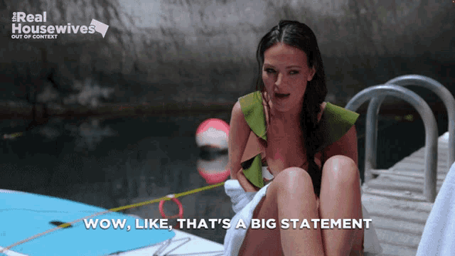 a woman sitting on a dock with the words wow like that 's a big statement below her