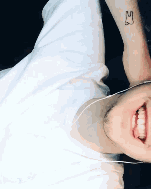 a man with a tattoo of a tooth on his arm