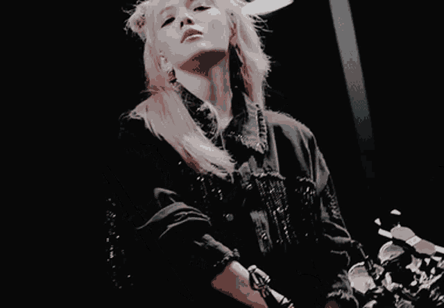 a woman with blonde hair is holding a sword