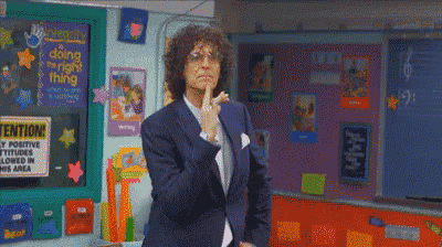 a man in a suit is standing in front of a classroom with a sign that says ' attention ' on it