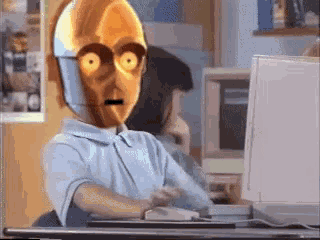 a cartoon character is sitting at a desk in front of a computer