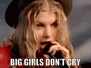 a woman singing into a microphone with the words big girls don 't cry