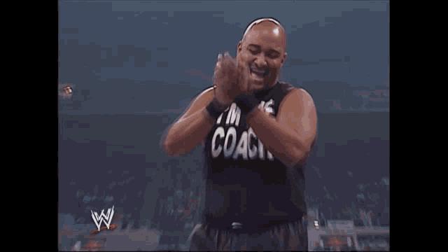 a man wearing a black shirt that says coach