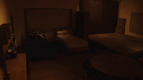 a person is laying on a bed with a suit that has the letter t on the front