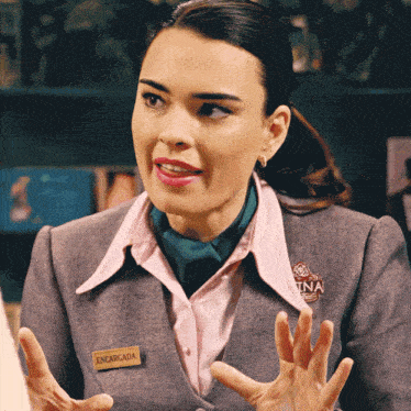 a woman wearing a pin that says encargada on it