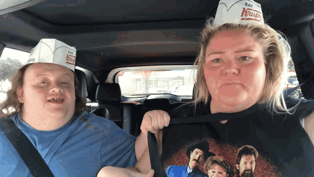 a man and a woman wearing doughnut hats