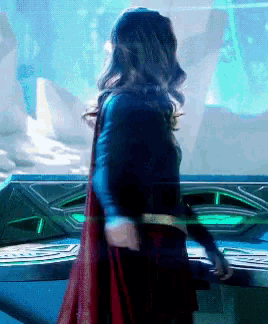 a woman in a superhero costume is standing in front of a blue screen