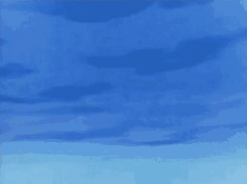 a brown and white dog is jumping in the air against a blue sky