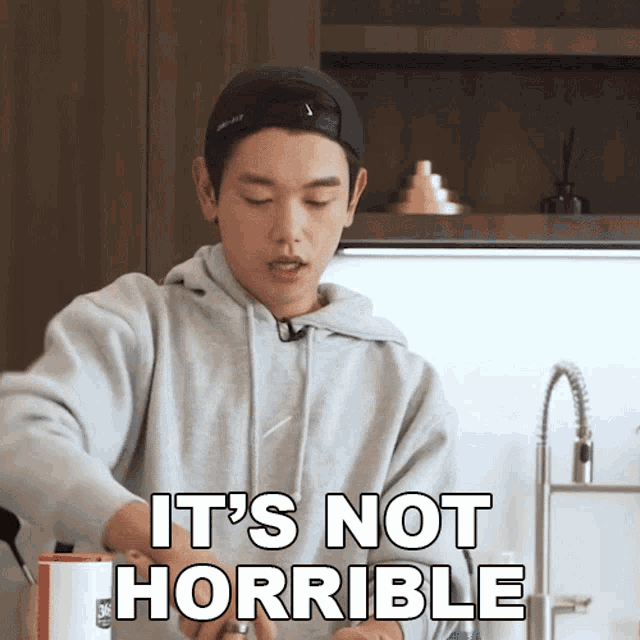 a man says it 's not horrible while cooking in the kitchen