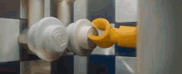 a close up of two lego pieces connected to each other in a room .