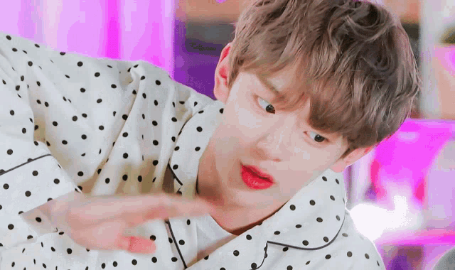 a close up of a person wearing a polka dot pajama shirt